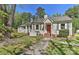 Charming home featuring a red front door, gray shutters and a well-maintained front yard at 1944 Garibaldi Ave, Charlotte, NC 28208