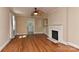 Living room with hardwood floors, fireplace, and ceiling fan at 1944 Garibaldi Ave, Charlotte, NC 28208