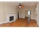 Cozy living room with hardwood floors, fireplace, and ceiling fan at 1944 Garibaldi Ave, Charlotte, NC 28208