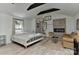 A well-lit main bedroom with a fireplace, beamed ceilings and a seating area at 1944 Garibaldi Ave, Charlotte, NC 28208