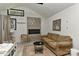 A cozy main bedroom featuring a fireplace, seating area and beamed ceilings at 1944 Garibaldi Ave, Charlotte, NC 28208