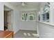 Bright sunroom featuring tiled floors, fresh paint, and large windows offering an abundance of natural light at 1944 Garibaldi Ave, Charlotte, NC 28208