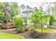 Landscaped backyard with deck, green lawn, and mature trees offering privacy and shade at 19729 Callaway Hills Ln, Davidson, NC 28036