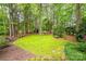 Spacious backyard featuring a lush lawn, mature trees, and wooded perimeter for privacy at 19729 Callaway Hills Ln, Davidson, NC 28036