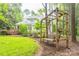 Beautiful backyard featuring a swing, lush lawn, and a view of the home, creating a serene outdoor setting at 19729 Callaway Hills Ln, Davidson, NC 28036