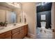 Bright bathroom features a classic vanity with marble countertop and a separate water closet for added privacy at 19729 Callaway Hills Ln, Davidson, NC 28036