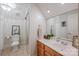 Well-lit bathroom featuring a vanity with ample counter space, toilet, and mirrored sliding door shower at 19729 Callaway Hills Ln, Davidson, NC 28036