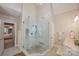 Bright bathroom with a glass-enclosed shower and a separate vanity area at 19729 Callaway Hills Ln, Davidson, NC 28036