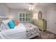Bright bedroom featuring a large window, colorful accents, and a comfortable bed, creating a cozy retreat at 19729 Callaway Hills Ln, Davidson, NC 28036