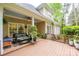 Covered deck with cozy seating, ceiling fan, and view of the landscaped backyard at 19729 Callaway Hills Ln, Davidson, NC 28036