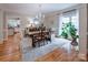 Bright dining room featuring a chandelier, large window, and hardwood floors at 19729 Callaway Hills Ln, Davidson, NC 28036