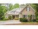 Inviting exterior showcasing a stone facade, tan siding, and a well-maintained front yard at 19729 Callaway Hills Ln, Davidson, NC 28036