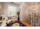 Cozy hallway with a chair and small writing desk alongside a window at 19729 Callaway Hills Ln, Davidson, NC 28036