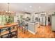 Bright eat-in kitchen features a cozy breakfast nook, stainless appliances, and a breakfast bar with granite countertops at 19729 Callaway Hills Ln, Davidson, NC 28036