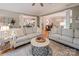Spacious living room featuring two sofas, hardwood floors, and a seamless transition to the dining and kitchen areas at 19729 Callaway Hills Ln, Davidson, NC 28036