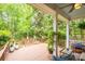 Charming porch with wooden deck, lush greenery, and comfortable seating, creating an inviting outdoor space at 19729 Callaway Hills Ln, Davidson, NC 28036