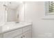 Modern bathroom featuring a sleek white vanity with countertop sink and a large mirror, enhancing the bright space at 213 Rosemont Ave, Kannapolis, NC 28081
