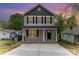 Charming two-story home with gray siding, black shutters, and a welcoming front porch at 213 Rosemont Ave, Kannapolis, NC 28081