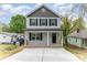 Charming two-story home featuring a covered front porch, gray siding and black shutters, offering classic curb appeal at 213 Rosemont Ave, Kannapolis, NC 28081