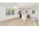 Bright kitchen featuring white cabinets, stainless steel appliances, and an island perfect for food preparation and casual dining at 213 Rosemont Ave, Kannapolis, NC 28081