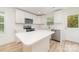 Beautiful, bright kitchen with white cabinets and stainless steel appliances offering a modern aesthetic at 213 Rosemont Ave, Kannapolis, NC 28081