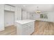 Bright, open-concept area with laminate flooring, seamlessly connects the kitchen and living space, perfect for entertaining guests at 213 Rosemont Ave, Kannapolis, NC 28081