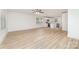 Open-concept living space featuring laminate flooring, offering a seamless flow into the kitchen for modern living at 213 Rosemont Ave, Kannapolis, NC 28081
