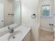 Bright bathroom featuring a white vanity, ample counter space, and a well-lit mirror at 2405 Kalis Pl, Charlotte, NC 28262