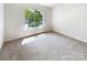 Comfortable bedroom featuring carpet flooring, a sunlit window, and neutral paint at 2405 Kalis Pl, Charlotte, NC 28262