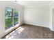 Inviting living room with hardwood floors, large windows, and plenty of natural light at 2405 Kalis Pl, Charlotte, NC 28262