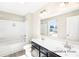Bathroom featuring double sinks, a shower, and a window for natural light at 2414 Morgan Hills Dr # 296P, Albemarle, NC 28001