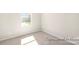 Bright bedroom featuring carpet, a window, and a wall outlet at 2414 Morgan Hills Dr # 296P, Albemarle, NC 28001