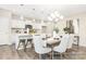 Open concept dining space features elegant lighting and a kitchen with barstool seating at 2414 Morgan Hills Dr # 296P, Albemarle, NC 28001