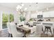 Elegant dining area features a modern chandelier, seating for six, and adjacent kitchen at 2414 Morgan Hills Dr # 296P, Albemarle, NC 28001