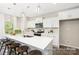 Bright kitchen features white cabinets, stainless steel appliances, an eat-in island, and pendant lighting at 2414 Morgan Hills Dr # 296P, Albemarle, NC 28001