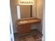 Bathroom featuring oak vanity and framed mirror with modern lighting at 2440 Mint Thistle Ct, Charlotte, NC 28269