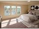 Bright bedroom featuring large windows and neutral décor that provide ample natural light at 2440 Mint Thistle Ct, Charlotte, NC 28269