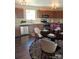 Eat-in kitchen featuring stainless steel appliances, granite countertops, and hardwood flooring at 2440 Mint Thistle Ct, Charlotte, NC 28269