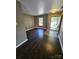 Inviting living room featuring hardwood floors and an open doorway at 2440 Mint Thistle Ct, Charlotte, NC 28269