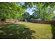 Expansive backyard with a lush lawn, storage shed, and fenced perimeter, perfect for outdoor enjoyment at 2601 Dora Dr, Charlotte, NC 28215