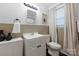 Bathroom featuring a decorative mirror, a neutral color scheme, and a toilet at 2601 Dora Dr, Charlotte, NC 28215