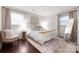 Stylish bedroom featuring a metal bed frame, area rug, and modern decor at 2601 Dora Dr, Charlotte, NC 28215