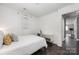 Bright bedroom with hardwood floors, white walls, and a modern console table at 2601 Dora Dr, Charlotte, NC 28215