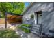 Exterior view of carport and entrance on gray brick home at 2601 Dora Dr, Charlotte, NC 28215