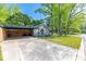 Exterior view of a gray home featuring a covered parking area and green lawn at 2601 Dora Dr, Charlotte, NC 28215
