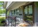 Close up of front porch with chairs and glass front door at 2601 Dora Dr, Charlotte, NC 28215