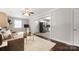 View of the living room showcasing hardwood floors, comfortable sofa, and access to the kitchen at 2601 Dora Dr, Charlotte, NC 28215