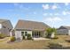 Spacious backyard with a covered patio, perfect for entertaining, surrounded by neat landscaping and lush greenery at 2704 Watergarden St, York, SC 29745