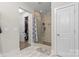 Bathroom featuring a tiled shower with a glass door and built-in shelves at 2704 Watergarden St, York, SC 29745