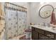 Bathroom featuring a vanity with marble countertop, shower with patterned curtain and a framed circular mirror at 2704 Watergarden St, York, SC 29745